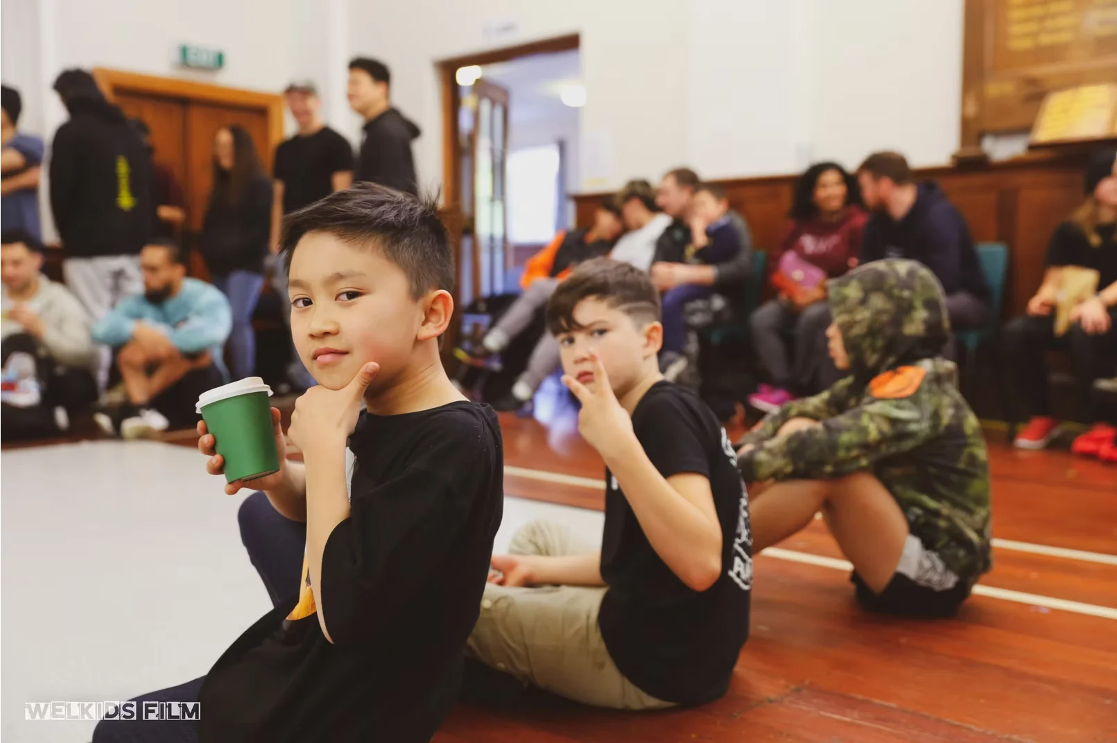 Kids posted up at the edge of the cypher