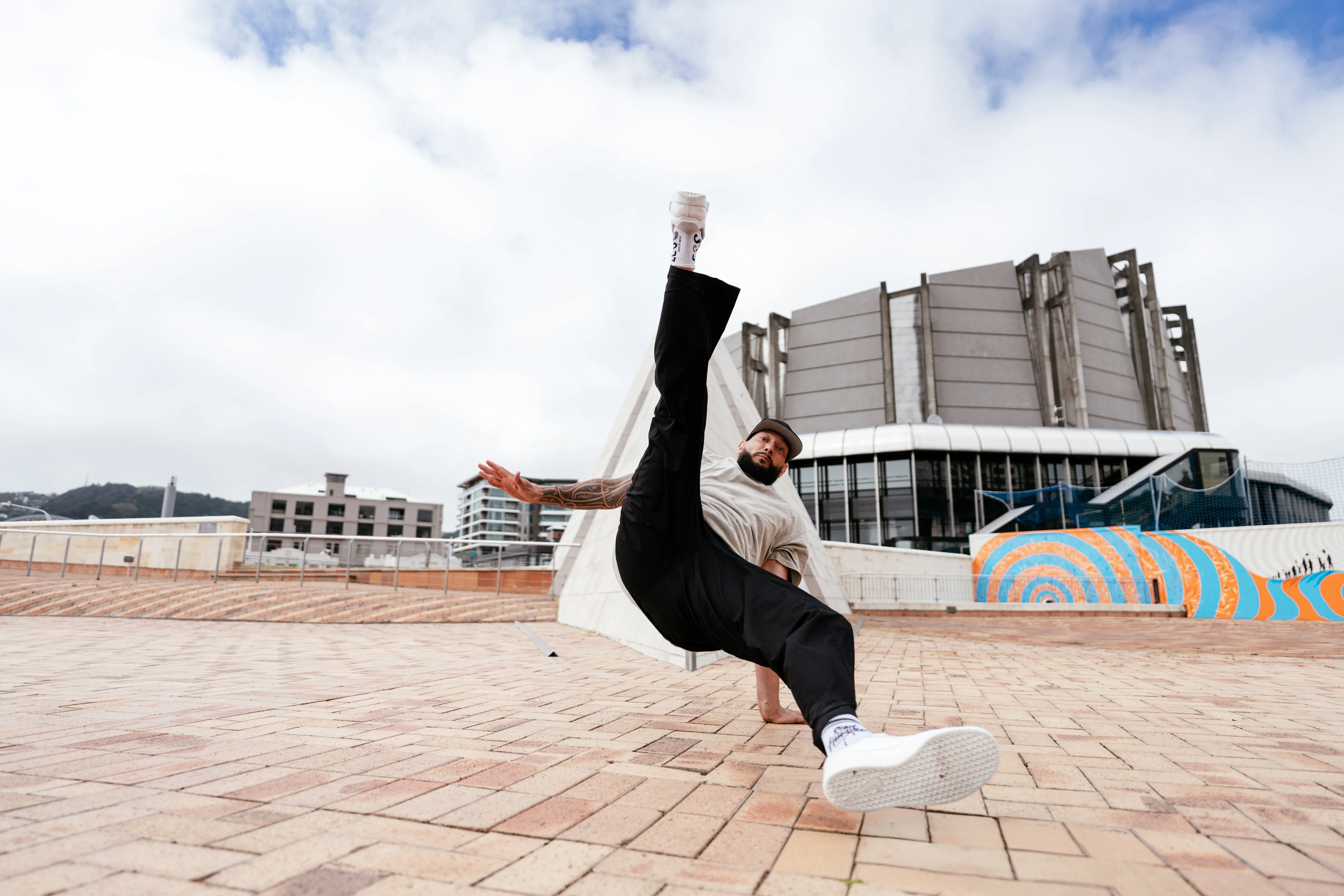 One-hand freeze in front of a Wellington mural